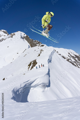Skier on mountains, extreme jump. Winter sport.
