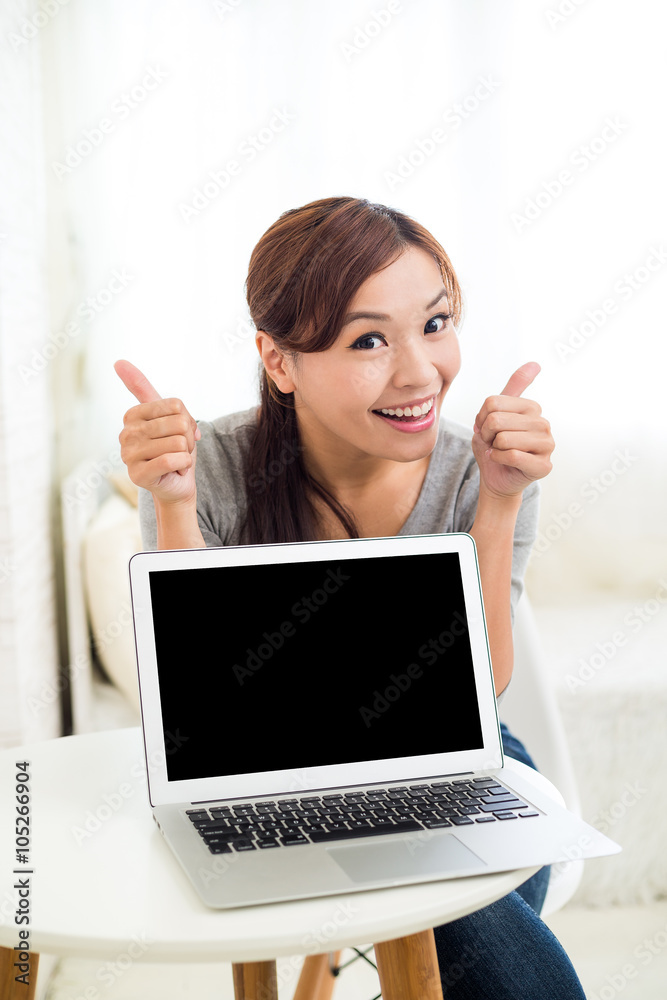 Young woman showing thumb up and laptop computer blank screen Young woman showing thumb up and laptop computer blank screen