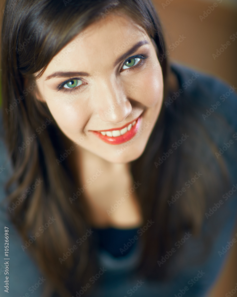 Close up face portrait of toothy smiling young woman looking up Close up face portrait of toothy smiling young woman looking up