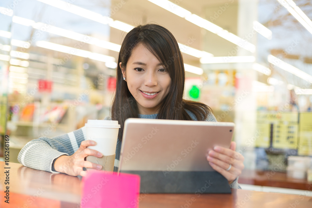 Young woman look at digital tablet in coffee shop Young woman look at digital tablet in coffee shop
