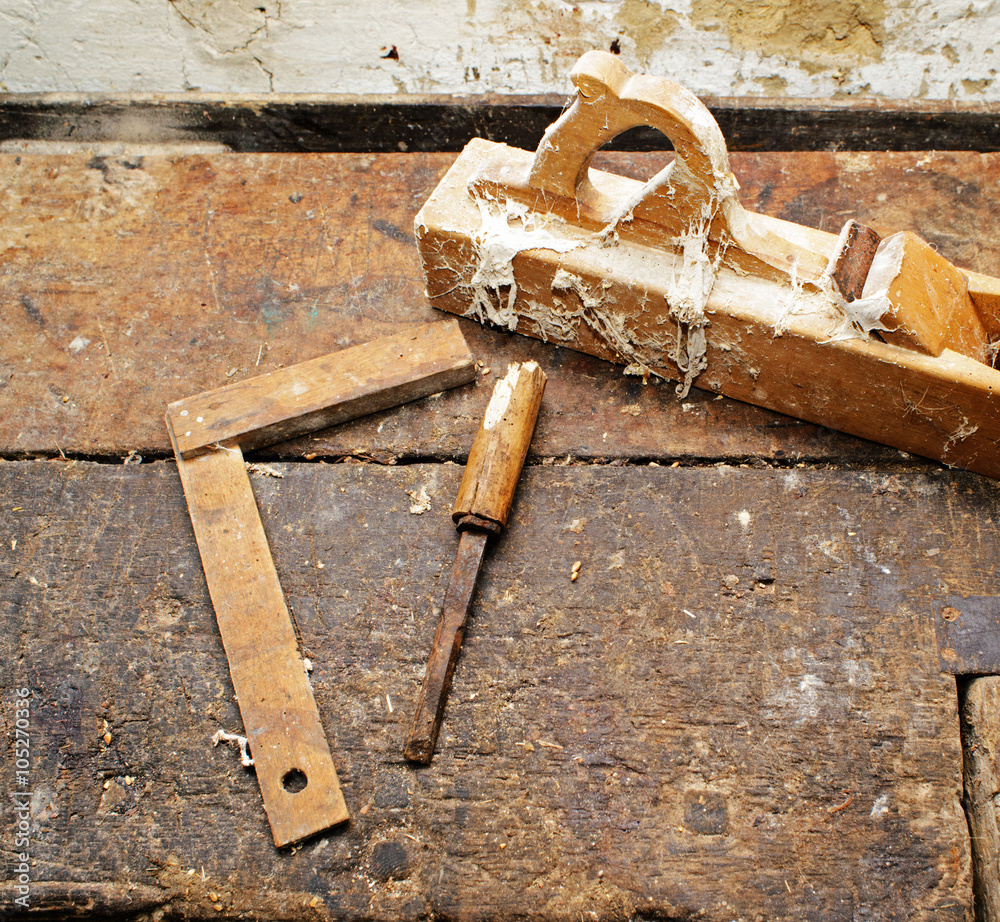 Old wooden plane on dirty table, struck by termites Old wooden plane on dirty table, struck by termites