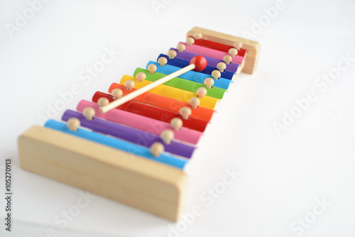 Colorful baby xylophone with stick isolated over white background