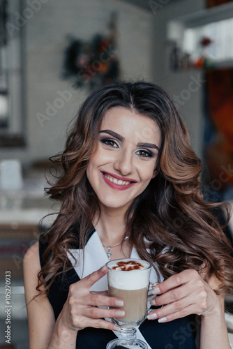 Business lady in cafe drinking latte
