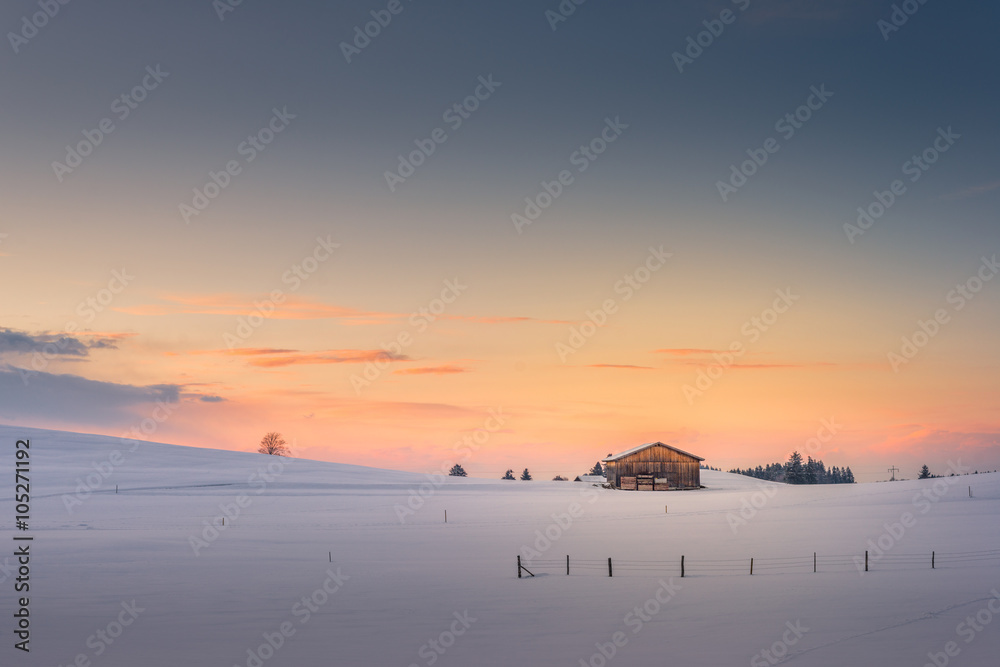 single hut at afterglow sunset sky in winter