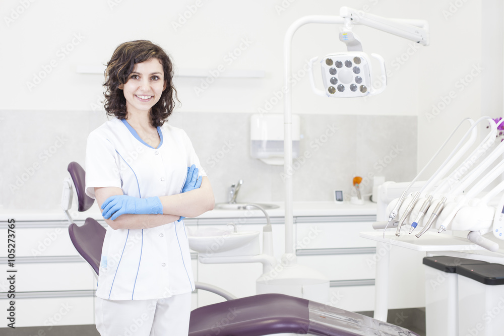 Fototapeta premium Young professional woman dentist in the dental office