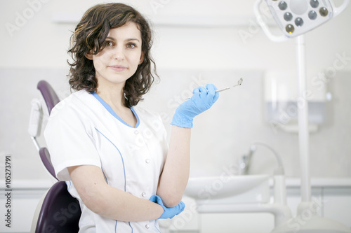 Young professional woman dentist in the dental office