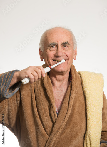 old man brushing his teeth