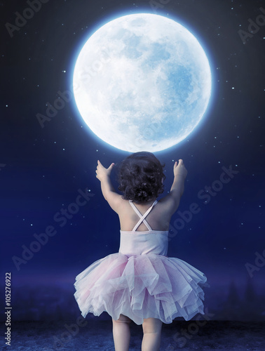Little baby girl reaching to the moon