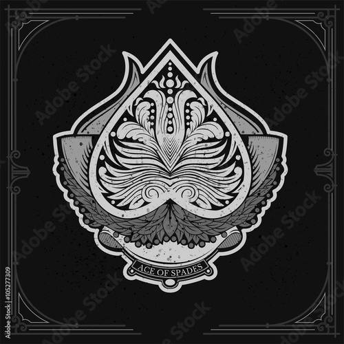 Ace of spades with laurel wreath and floral pattern inside. White on black
