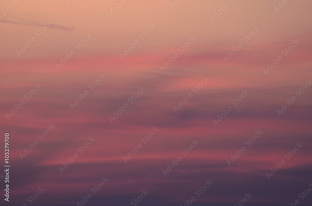Pink blurred background of sunset cloudy sky 