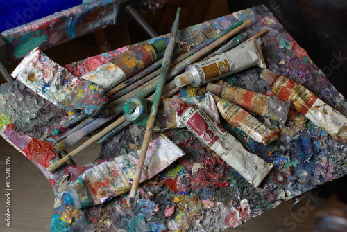 Painting palette with paint tubes and brusher   © Serg
