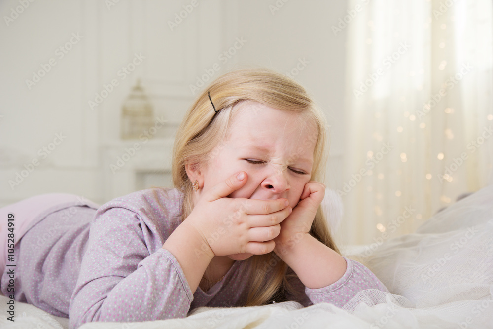 Happy cute child girl yawning in the bed Happy cute child girl yawning in the bed