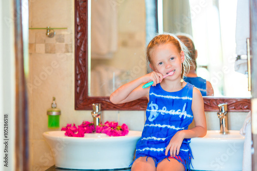 Dental hygiene. Adorable little smile girl brushing her teeth