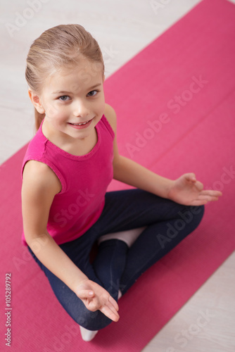 Domestic yoga trainings with little girl