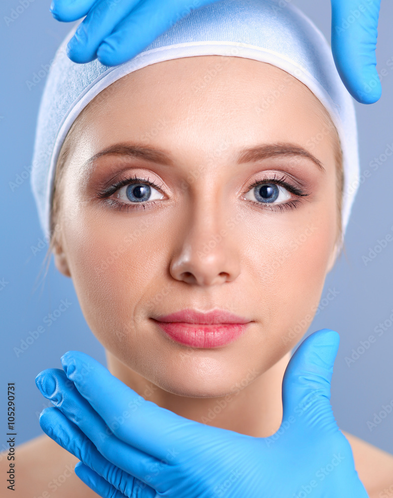 Cosmetic injection on the pretty woman face. Isolated on gray background Cosmetic injection on the pretty woman face. Isolated on gray background