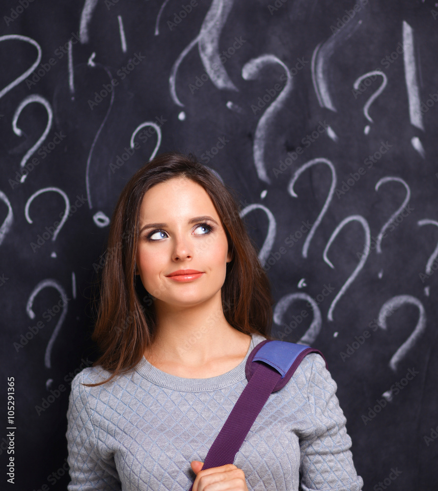 Young girl with question mark on a gray background Young girl with question mark on a gray background