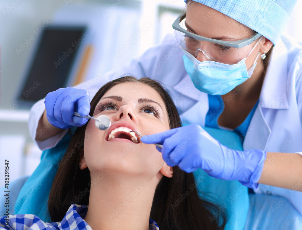 Woman dentist working at her patients teeth Woman dentist working at her patients teeth