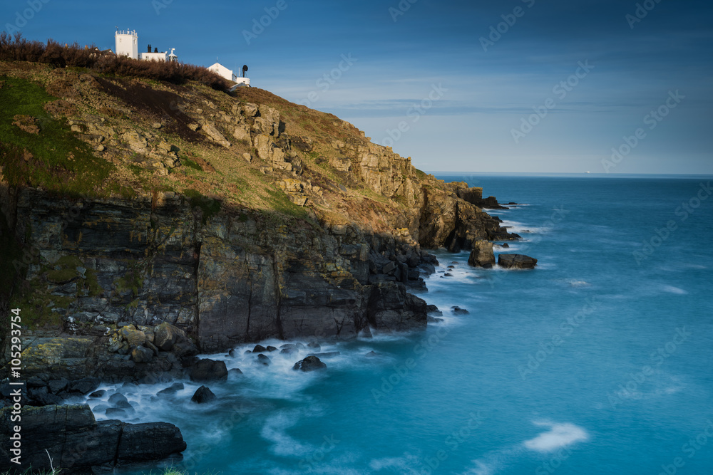 Trinity Lighthouse on rocky coast in Cornwall, UK.