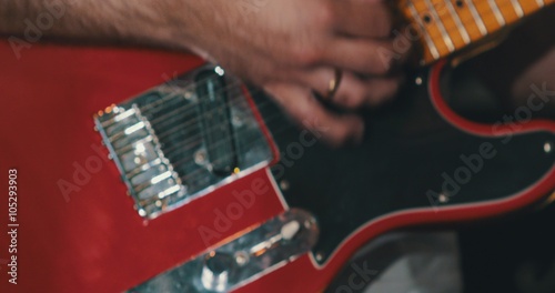 A finger masterfully strumming the guitar  photo