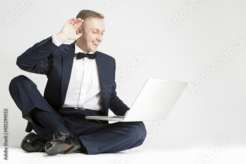 Happy Smiling Caucasian Man in Blue Suit with Laptop Chatting and Chatting