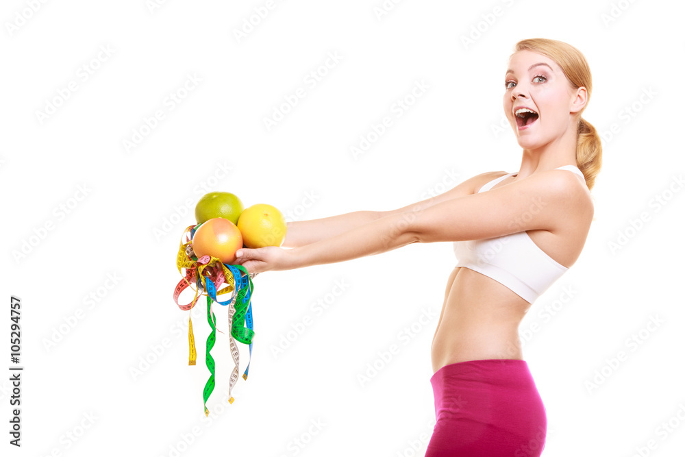 Happy woman holding grapefruits and tape measures. Happy woman holding grapefruits and tape measures.