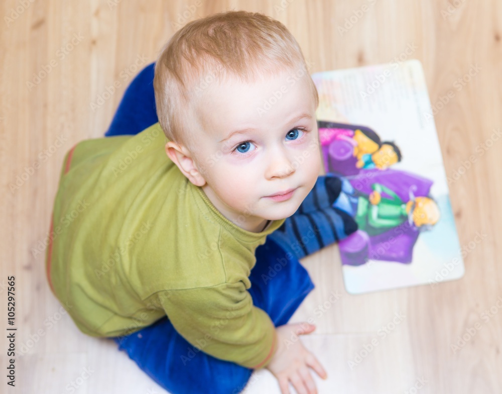 Small boy watching illustrated book Small boy watching illustrated book