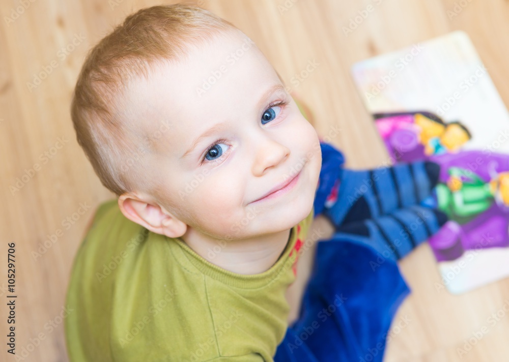 Small boy watching illustrated book Small boy watching illustrated book