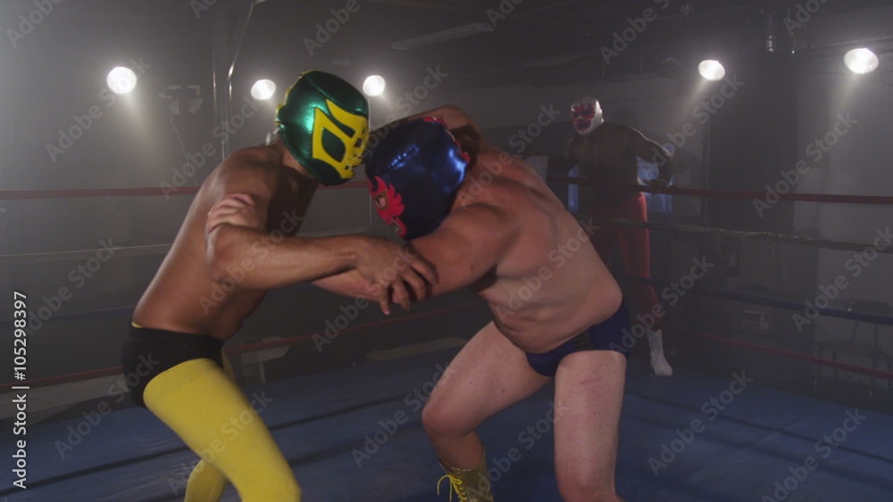 Masked wrestler spins opponent on shoulders