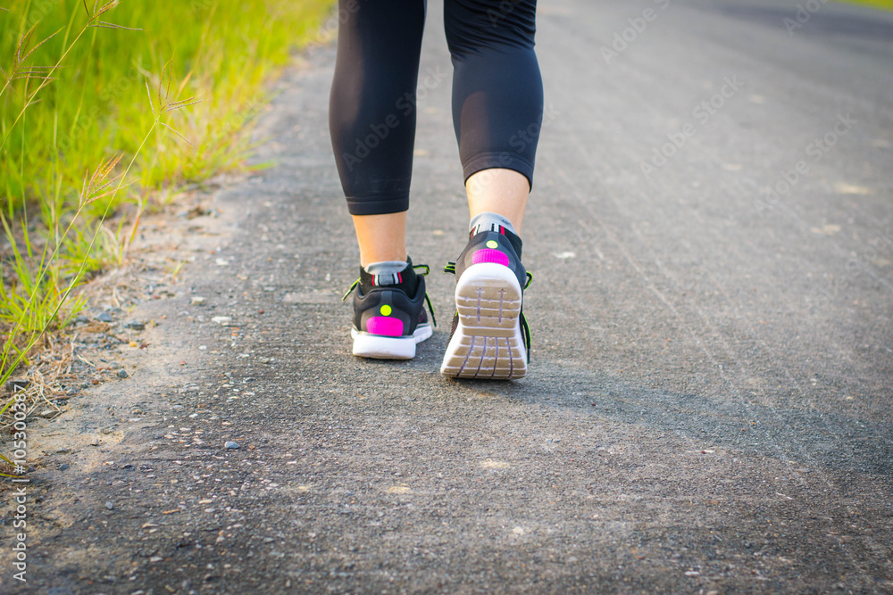 woman wearing sports shoes, walking or running