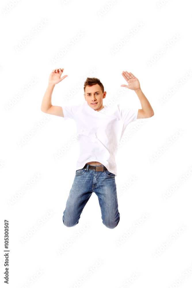 Young guy jumping from happiness