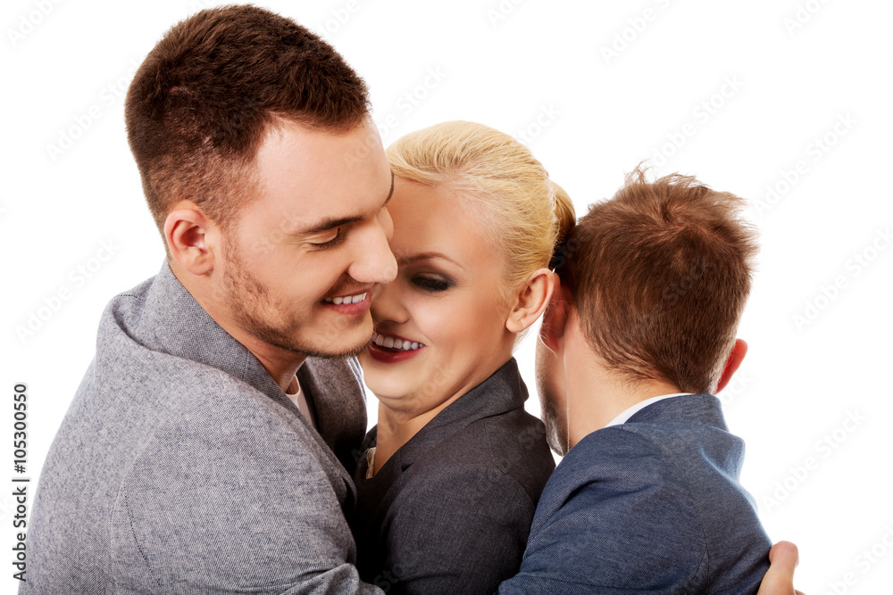 Happy group of three people hugging Happy group of three people hugging