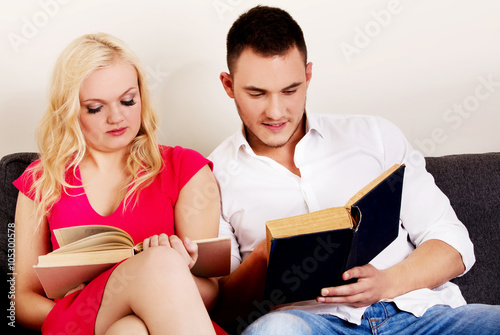 Young couple reading a books together