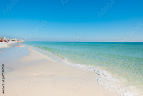 sunny day white sand beach with blue sky and blue green water