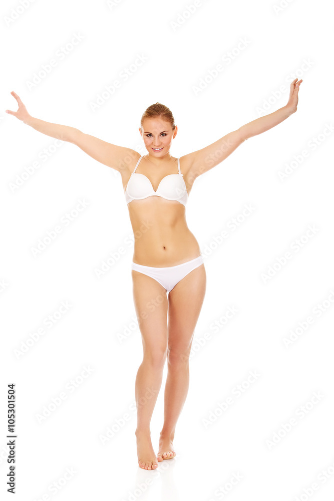 Happy young woman in white underwear holds her arms up Happy young woman in white underwear holds her arms up