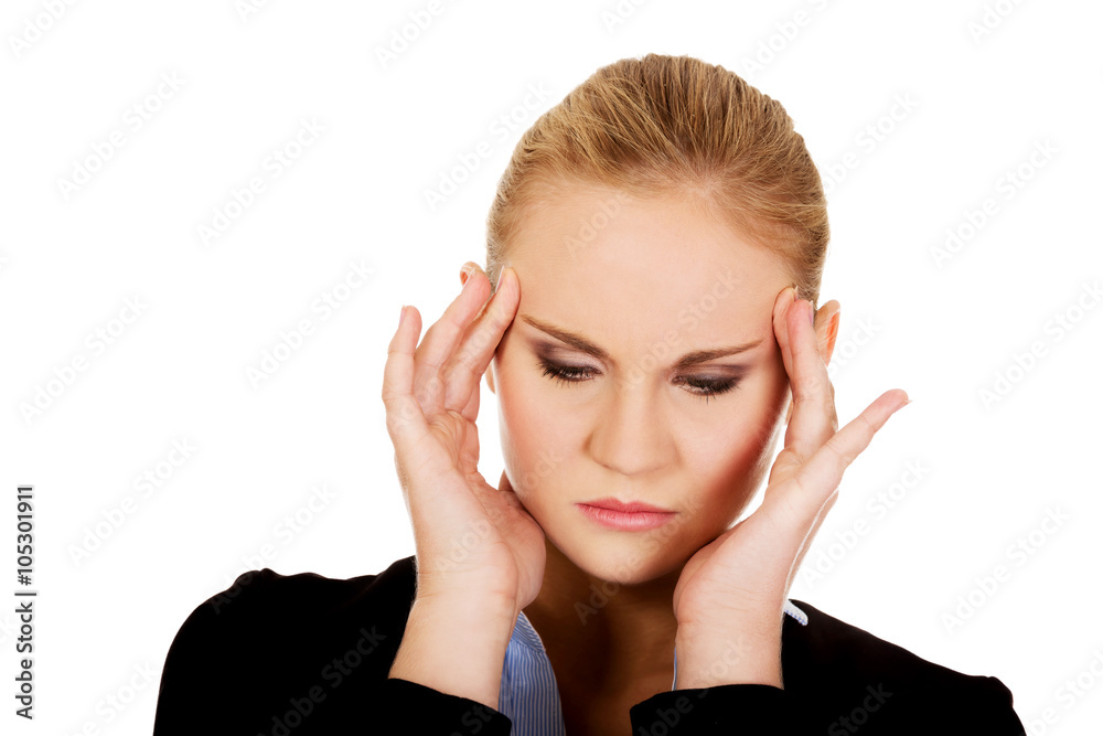 Business woman with a huge headache holding head Business woman with a huge headache holding head