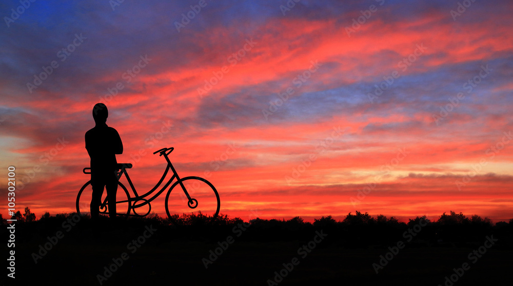 Cyclists at sunset background.