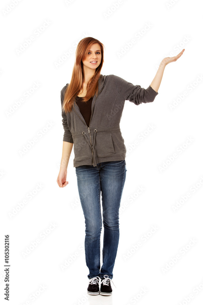 Teenage woman presenting something on open palm Teenage woman presenting something on open palm
