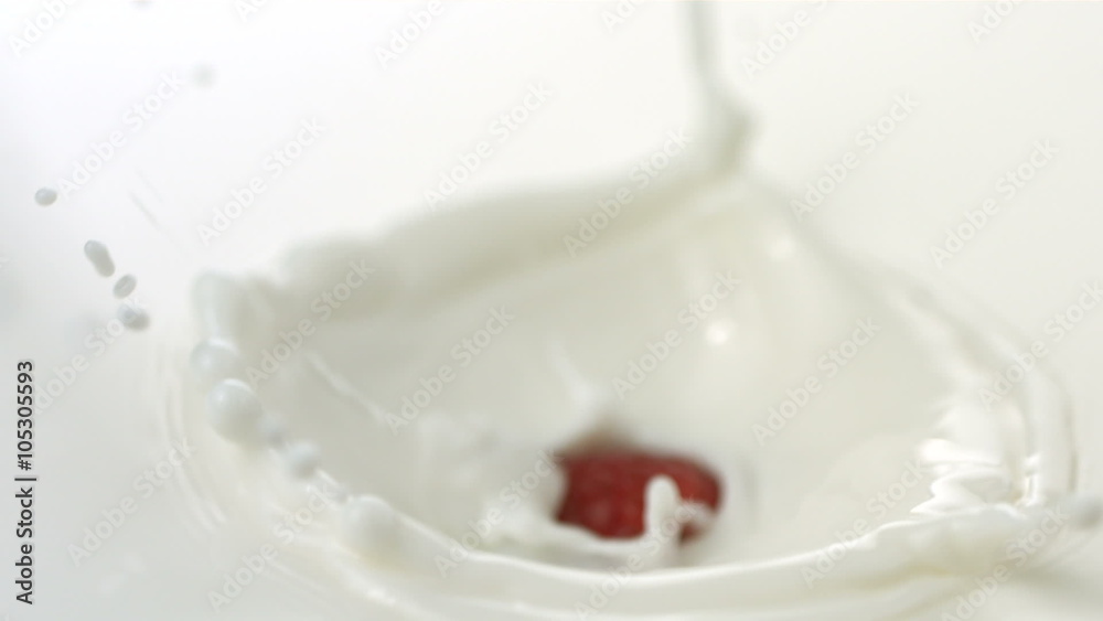 Raspberry splashing into cream, slow motion Raspberry splashing into cream, slow motion