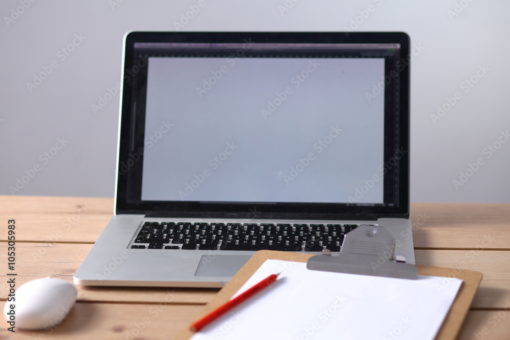 Office table with blank notepad and laptop Office table with blank notepad and laptop