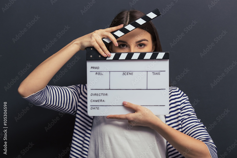 Fototapeta premium Handsome girl with clapperboard