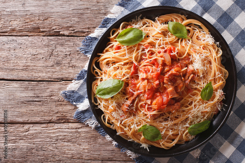 Amatriciana Spaghetti with cheese and basil on a plate. horizontal top view
 photo