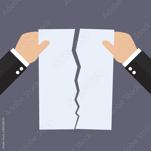 Hands tearing apart document paper