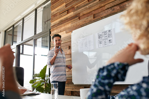 Young man discussing new mobile application during a creative pr