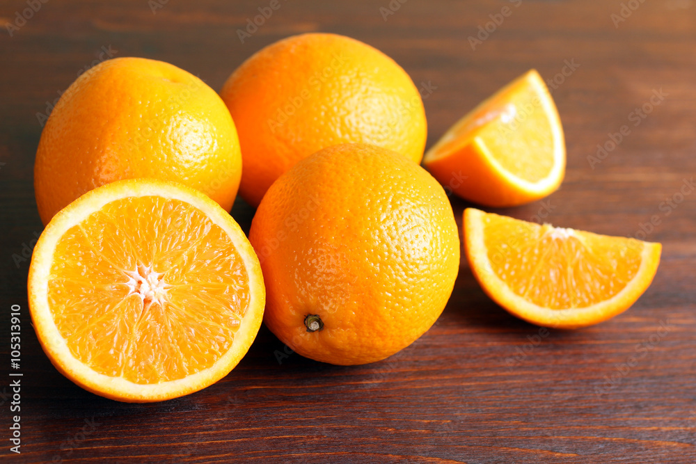 delicious sliced oranges lay in a heap on brown wooden table delicious sliced oranges lay in a heap on brown wooden table