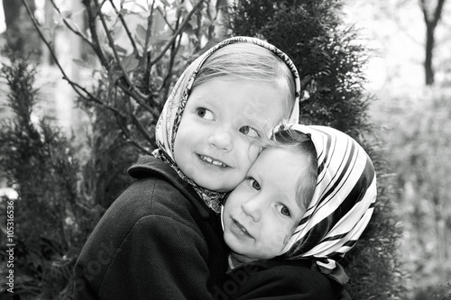 Photo in retro style. Cute little girls (sisters 3 and 4 years)