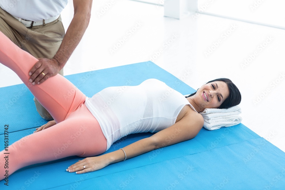 Doctor giving physiotherapy to pregnant woman Doctor giving physiotherapy to pregnant woman