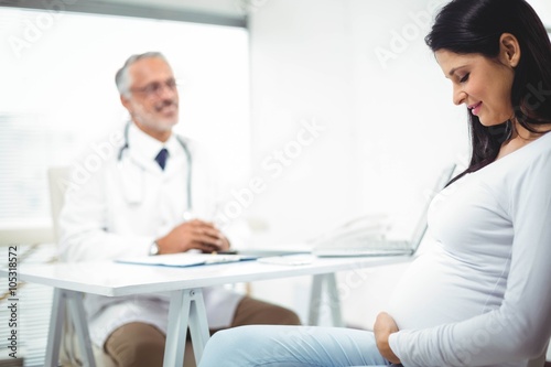 Pregnant woman sitting at clinic for health checkup © WavebreakMediaMicro