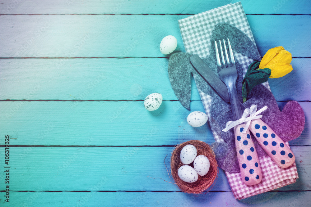 Easter table setting with flowers and eggs on old wooden table Easter table setting with flowers and eggs on old wooden table