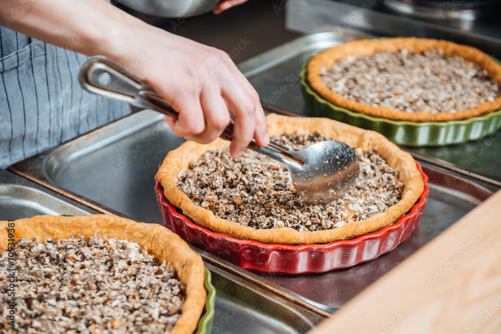 Cheif cook making pie with meat filling on the kitchen Cheif cook making pie with meat filling on the kitchen