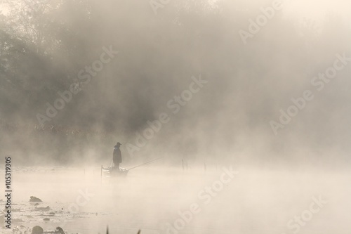 Fishing in foggy morning